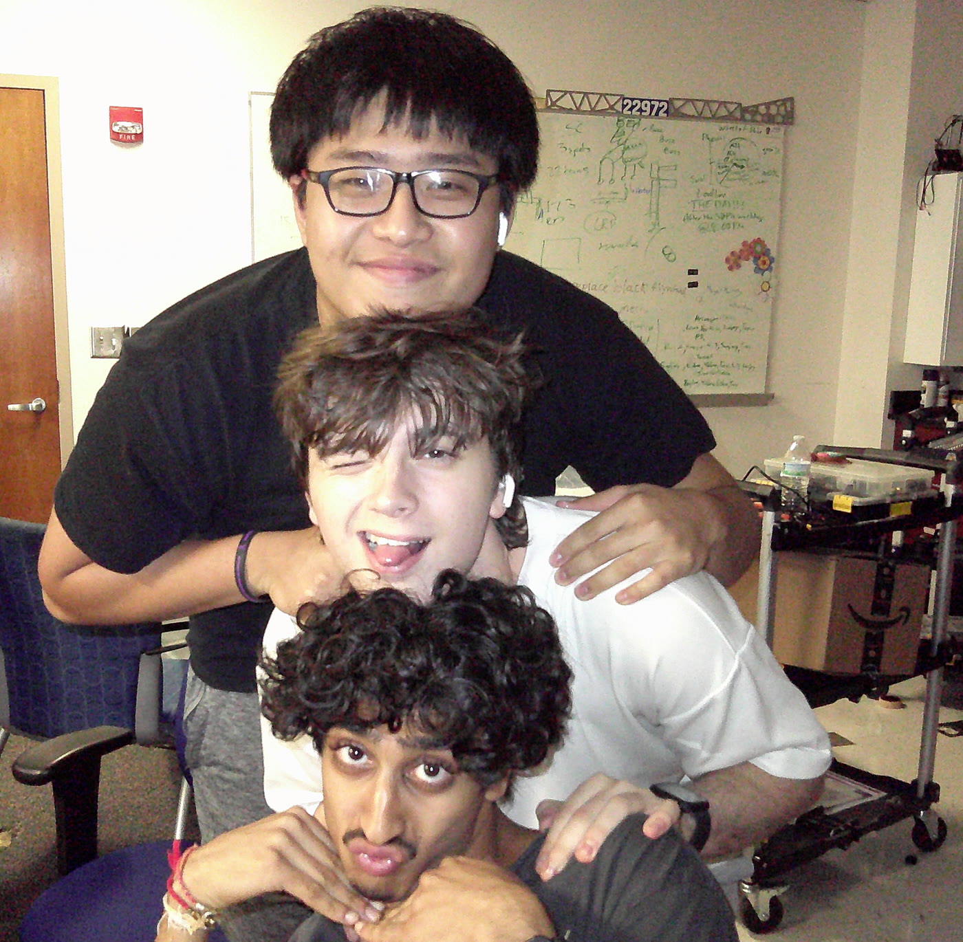 Anh, Tristan, and Miten stacked up in the GSSM robotics lab